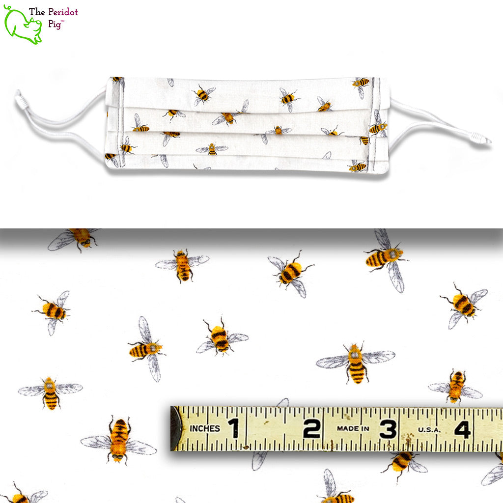 Tiny little bees on a white background fabric pattern called Bitty Bees. A view showing the mask and the scale of the fabric.