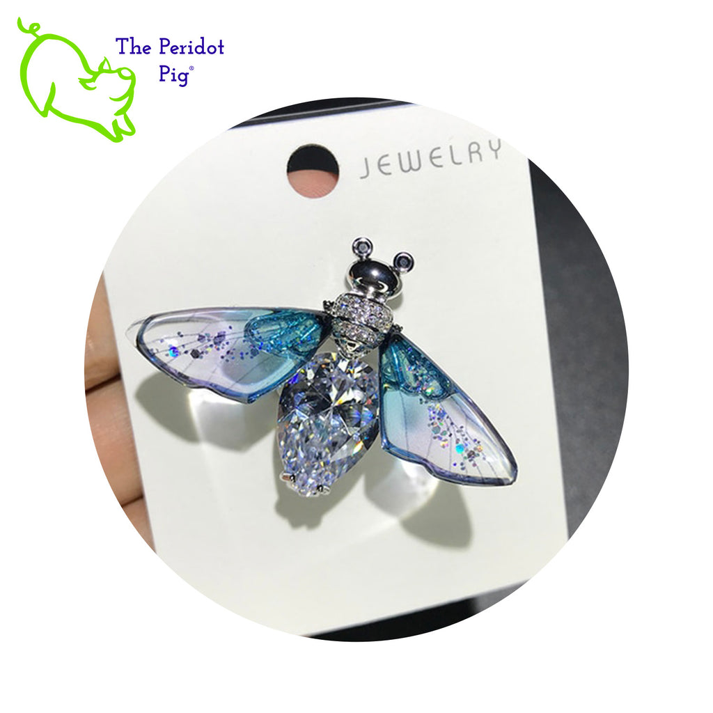 What a blingy bee! These brilliant, cubic zirconia bees are nearly 1.7" wide! They have gold plated bodies and acrylic wings. Sparkly!! Front view with blue wings shown.