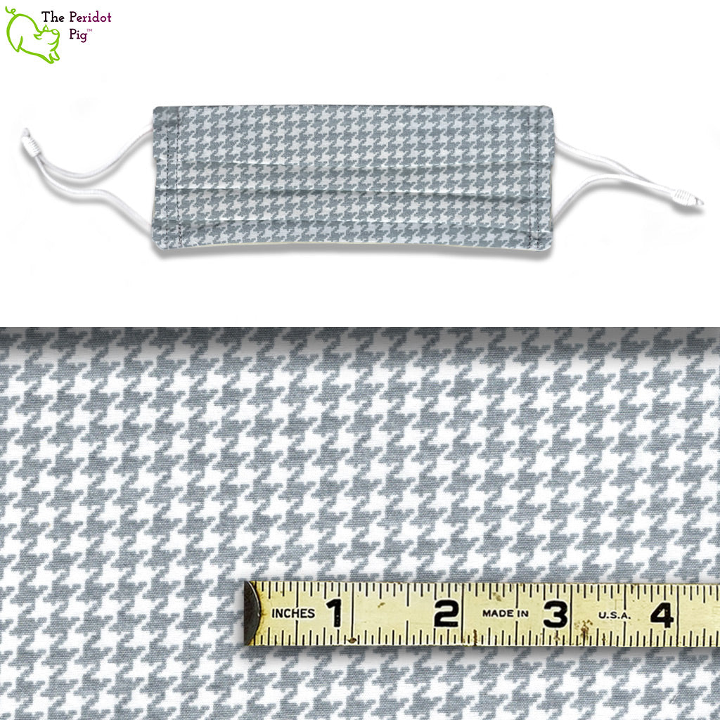 A view showing the mask and the scale of the pattern. The Grey Houndstooth fabric is a mix of grey and white in a repeating houndstooth pattern. 