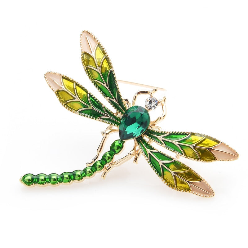 This delicate little dragonfly brooch is a shimmery green with a large green center rhinestone. It can be worn as a pin or attached to a necklace chain using the loop on the back. It's roughly 2" in each dimension. Front view