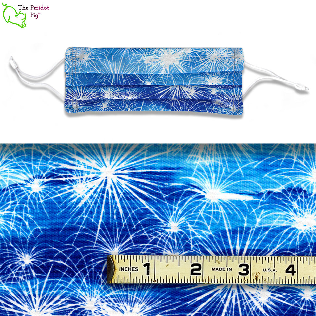 Sparklers and fireworks are always so festive. In this pattern, there are white fireworks on a blue cloudy background. View shows a mask and a scale view of the fabric.