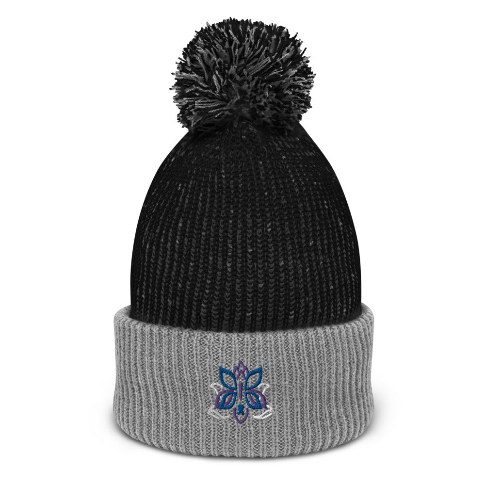 A comfy, cozy pom-pom beanie in gray and black featuring the Kristin Zako logo